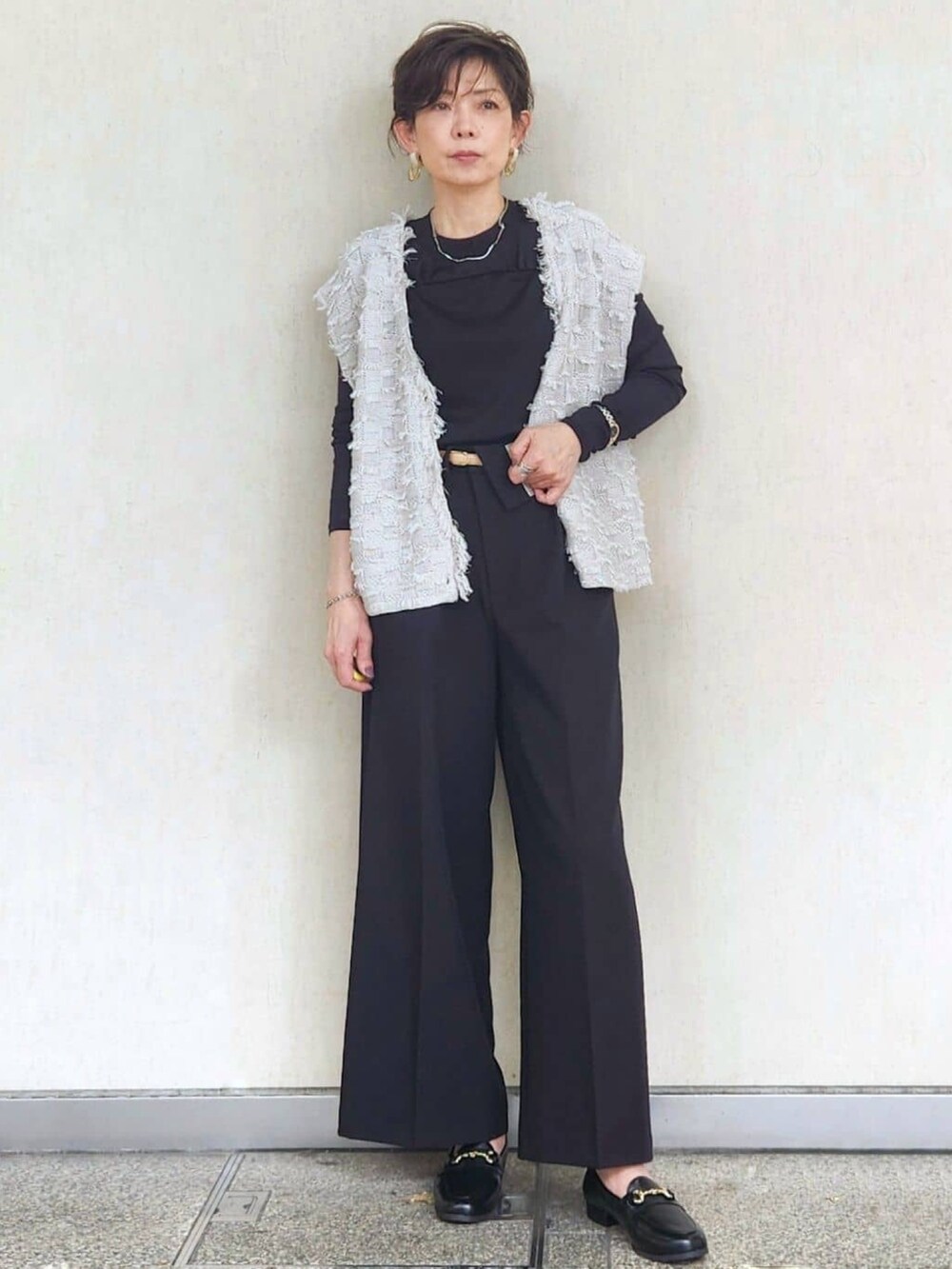 グレー系のニット/セーター、ブラック系のTシャツ/カットソー、ブラック系のその他パンツを着用したレディースの秋コーディネートの5枚目の写真