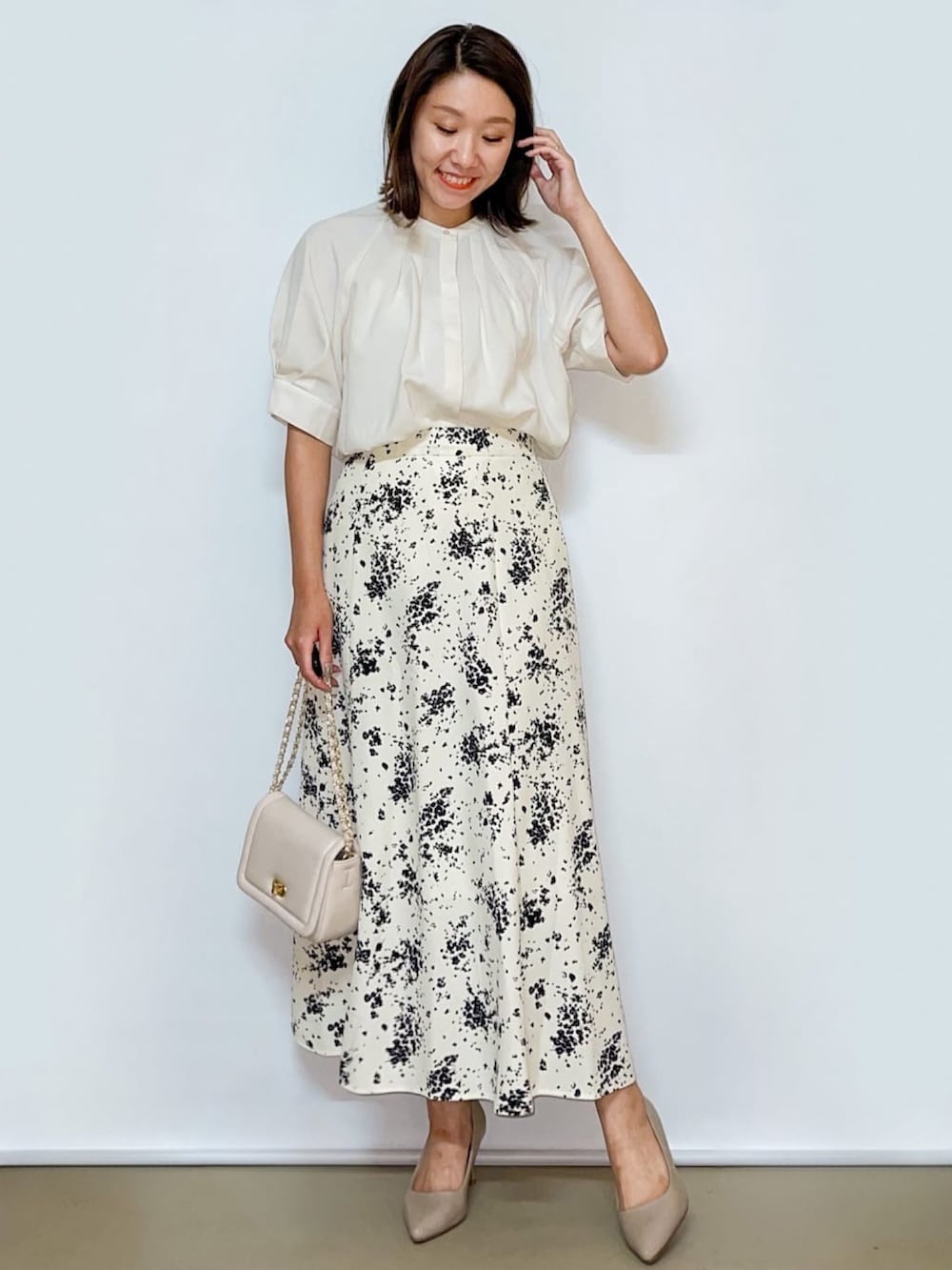 ホワイト系のシャツ/ブラウス、ホワイト系のスカート、ホワイト系のショルダーバッグを着用したレディースの夏コーディネートの3枚目の写真