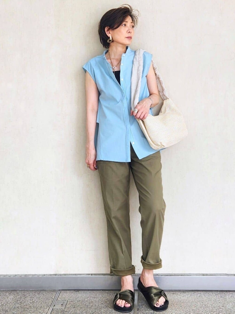 ブラック系のタンクトップ、ブルー系のシャツ/ブラウス、ベージュ系のショルダーバッグを着用したレディースの夏コーディネートの2枚目の写真