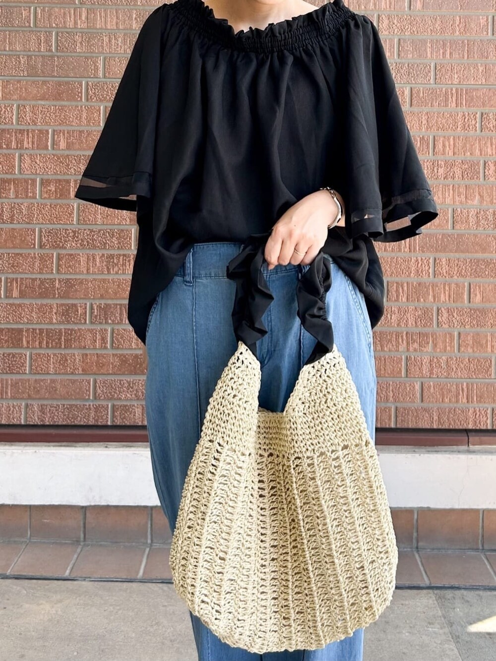 ブラック系のシャツ/ブラウス、ブラック系のサンダル、ベージュ系のショルダーバッグを着用したレディースの夏コーディネートの5枚目の写真