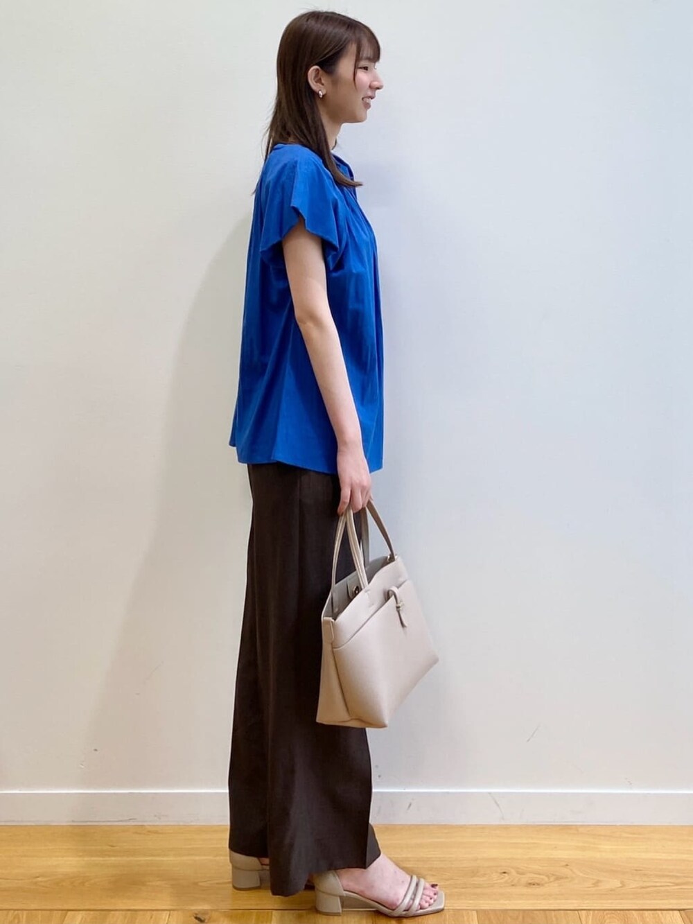 ブルー系のシャツ/ブラウス、ブラウン系のその他パンツ、ベージュ系のサンダルを着用したレディースの夏コーディネートの3枚目の写真