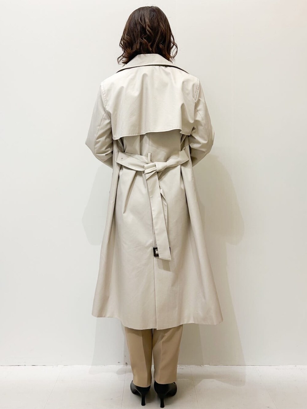 ベージュ系のその他パンツ、ホワイト系のシャツ/ブラウス、ベージュ系のトレンチコートを着用したレディースの冬コーディネートの3枚目の写真