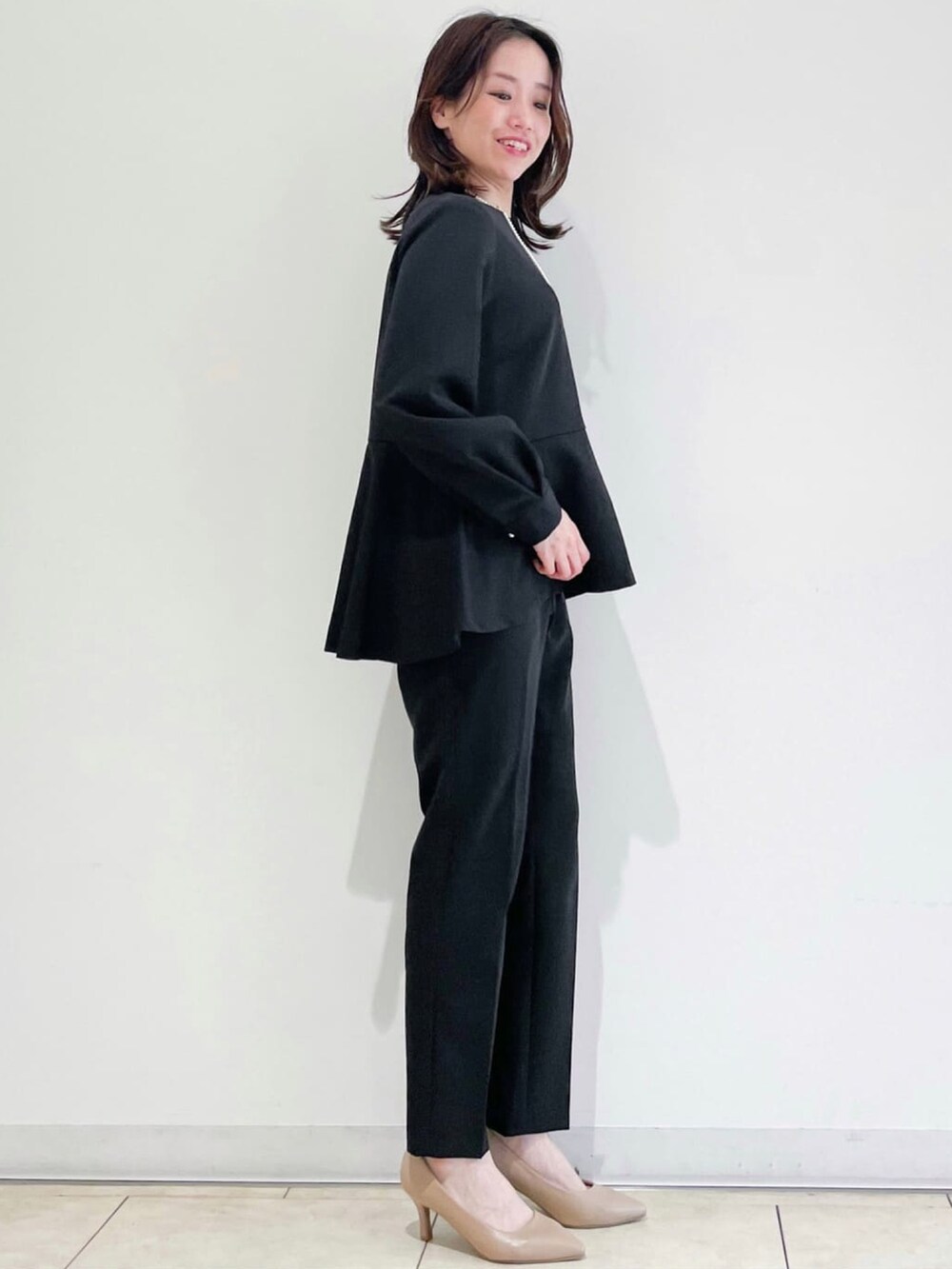 ブラック系のシャツ/ブラウス、ブラック系のその他パンツ、ベージュ系のトートバッグを着用したレディースの冬コーディネートの2枚目の写真