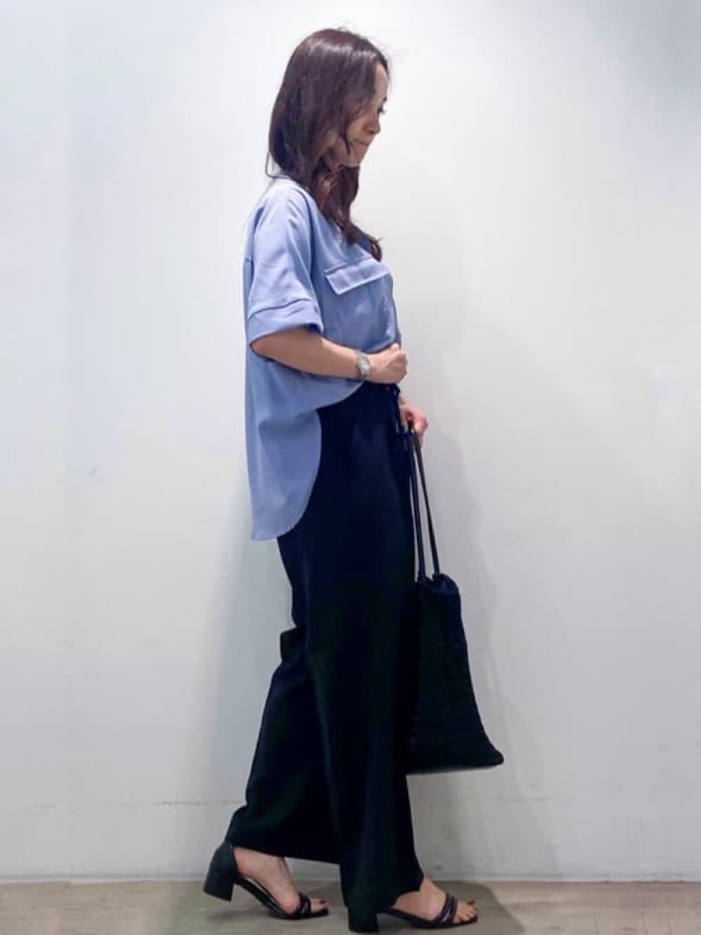 ブルー系のシャツ/ブラウス、ブラック系のその他パンツ、ブラック系のトートバッグを着用したレディースの春コーディネートの6枚目の写真