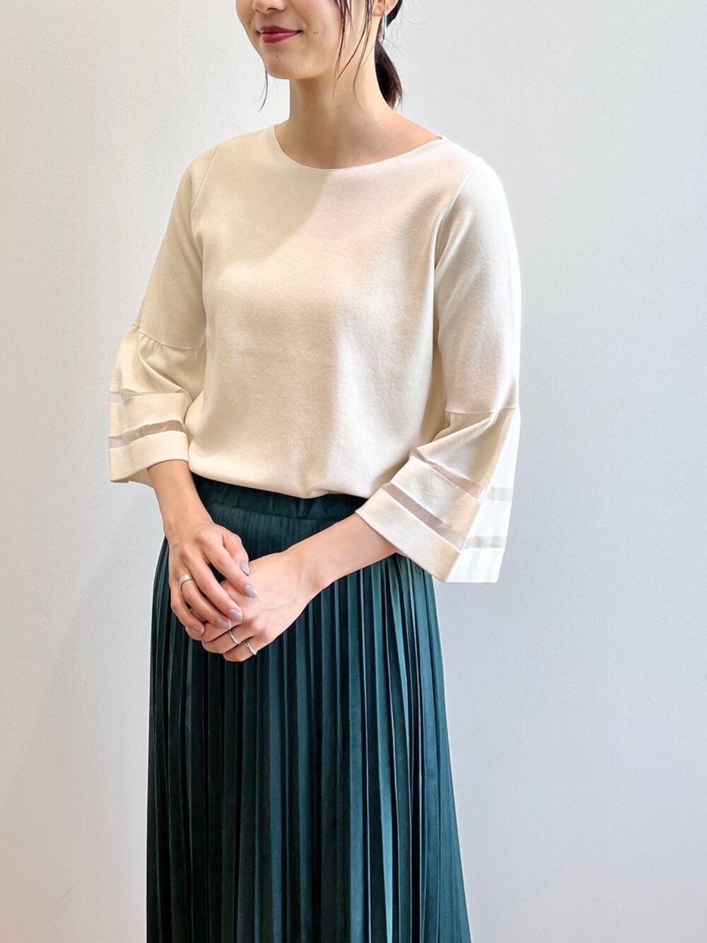 ブラウン系のブーツ、ホワイト系のニット/セーター、ブルー系のスカートを着用したレディースの夏コーディネートの5枚目の写真