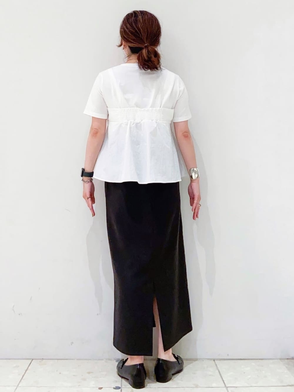 ホワイト系のTシャツ/カットソー、グレー系のスカート、シルバー系のトートバッグを着用したレディースの夏コーディネートの3枚目の写真