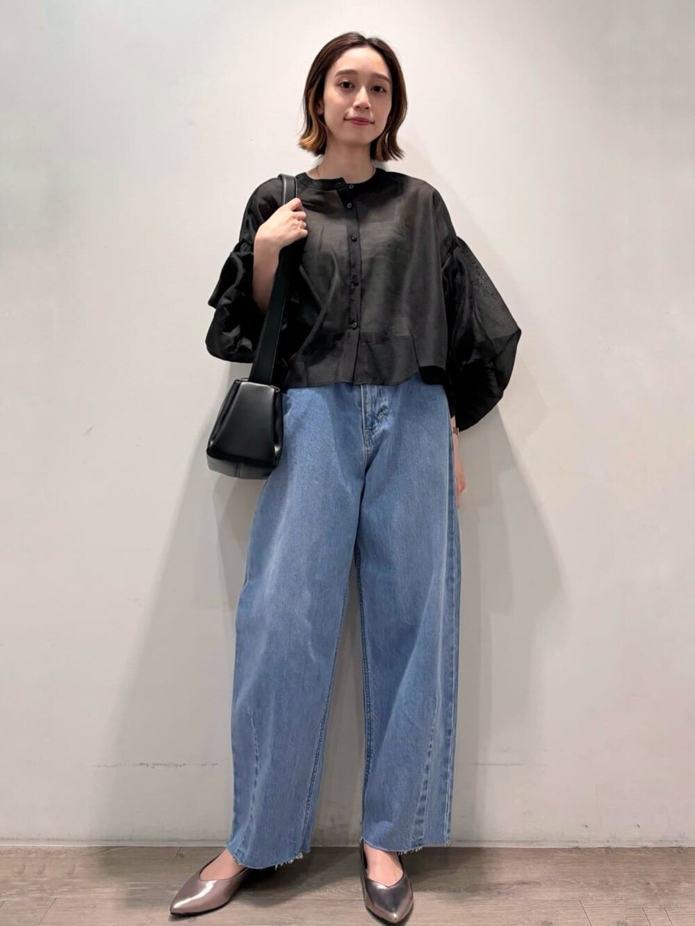 ブラック系のシャツ/ブラウス、シルバー系のパンプス、ブルー系のデニムパンツを着用したレディースの夏コーディネートの6枚目の写真