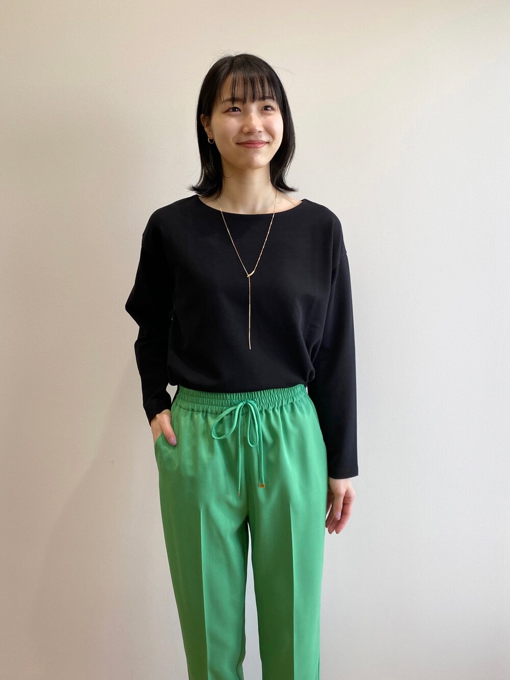 ブラック系のサンダル、グリーン系のその他パンツ、ベージュ系のトレンチコートを着用したレディースの春コーディネートの8枚目の写真