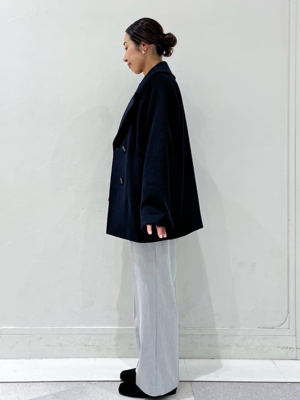 ブルー系のピーコート、レッド系のニット/セーター、グレー系のその他パンツを着用したレディースの秋コーディネートの3枚目の写真