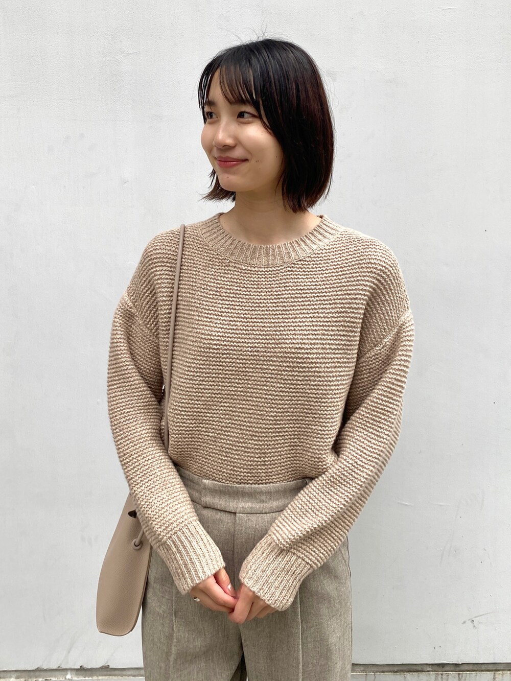 ベージュ系のチェスターコート、ベージュ系のその他パンツ、ホワイト系のブーツを着用したレディースの冬コーディネートの5枚目の写真