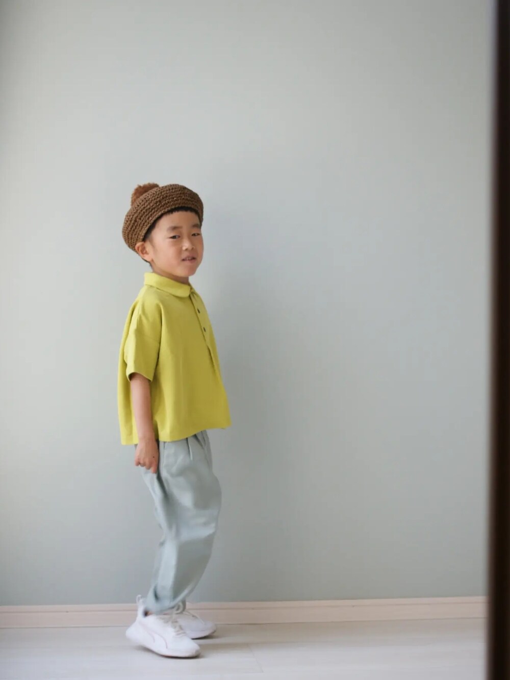 グリーン系のその他パンツ、グリーン系のポロシャツ、ホワイト系のスニーカーを着用したキッズの春コーディネートの2枚目の写真