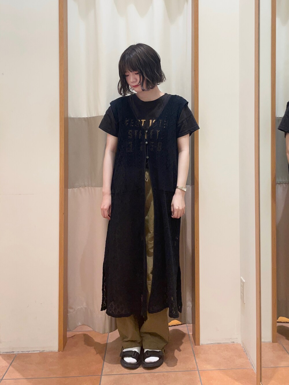 グレー系のTシャツ/カットソー、グリーン系のカーゴパンツ、ブラック系のワンピースを着用したレディースの夏コーディネートの2枚目の写真