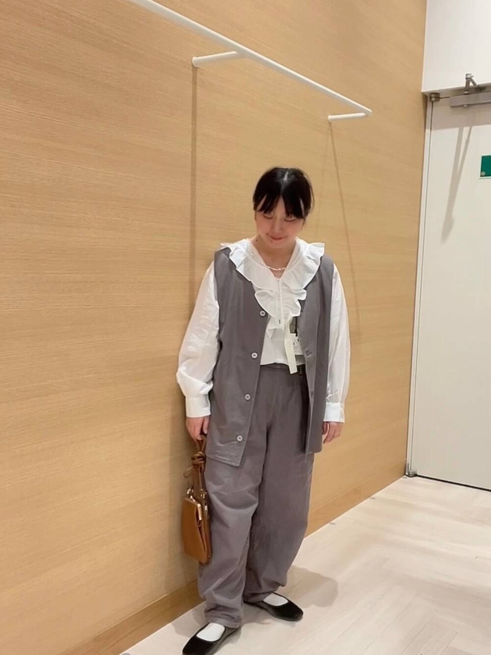 ホワイト系のシャツ/ブラウス、ブラウン系のデニムパンツ、ブラウン系のベストを着用したレディースの冬コーディネートの3枚目の写真