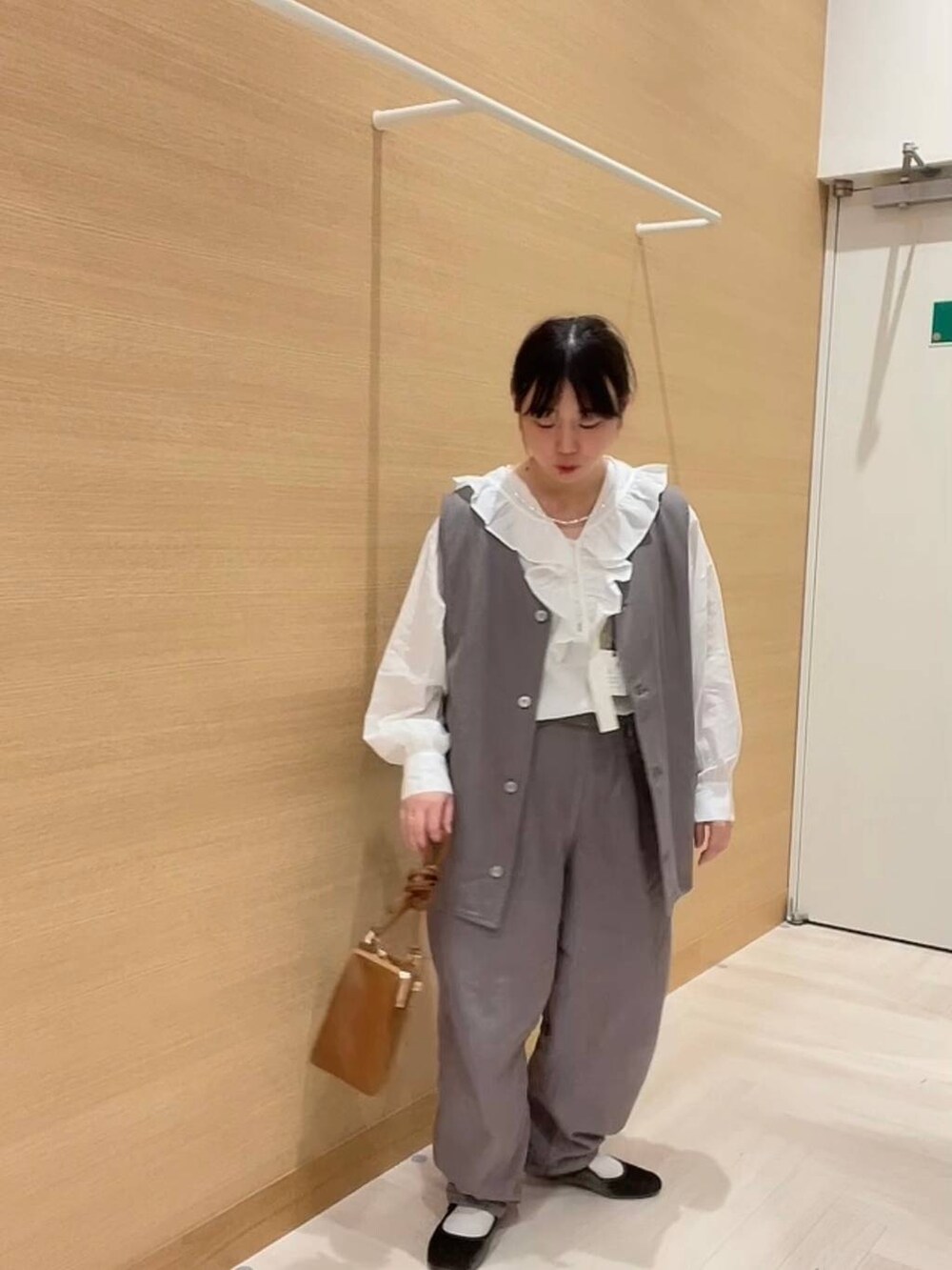 ホワイト系のシャツ/ブラウス、ブラウン系のデニムパンツ、ブラウン系のベストを着用したレディースの冬コーディネートの2枚目の写真