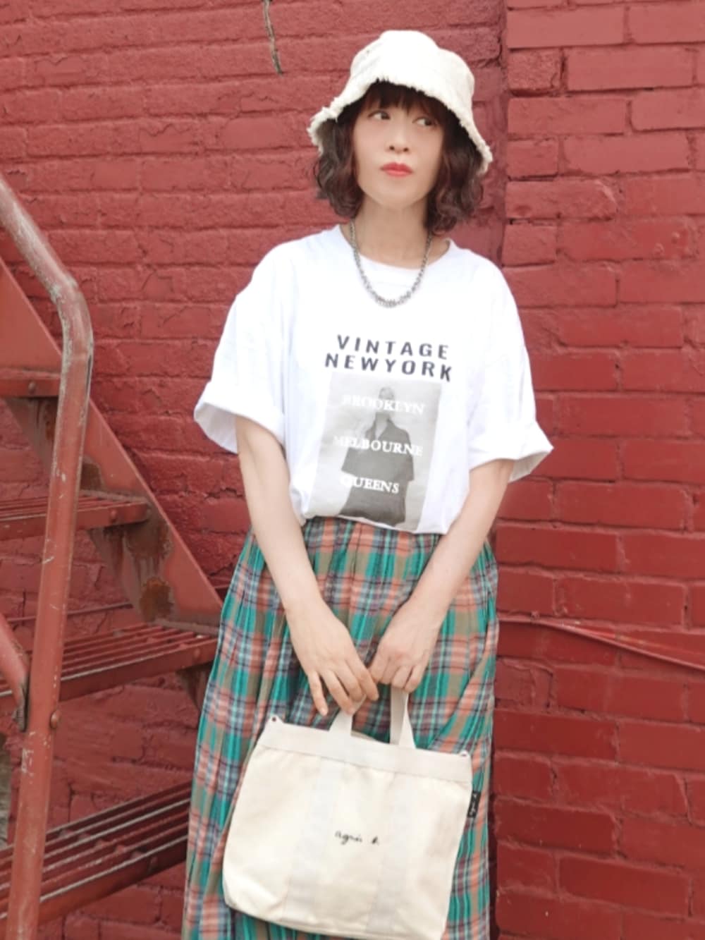 ホワイト系のTシャツ/カットソー、グリーン系のスカート、ホワイト系のトートバッグを着用したレディースの夏コーディネートの3枚目の写真
