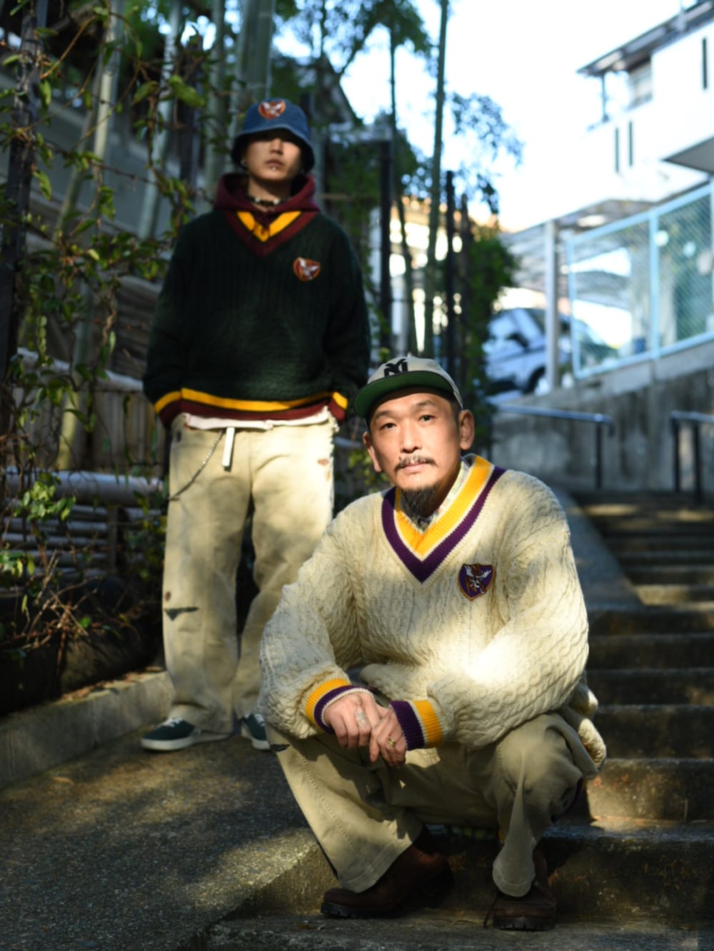 グリーン系のニット/セーター、ベージュ系のチノパンツ、ベージュ系のチノパンツを着用したメンズの冬コーディネートの2枚目の写真