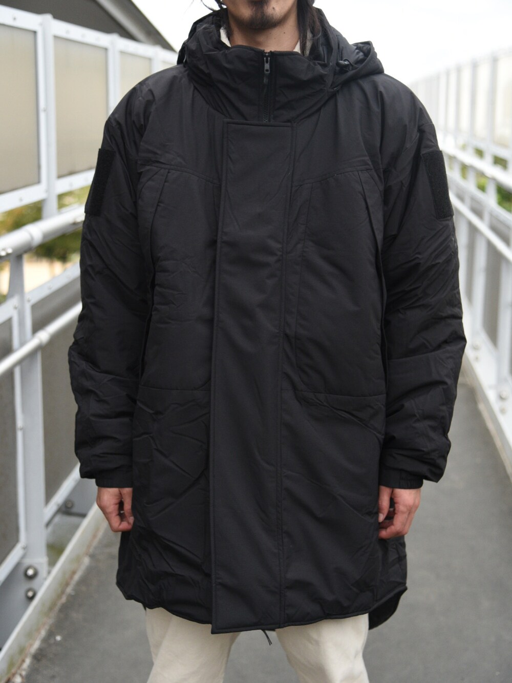 ブラック系のミリタリージャケットを着用したメンズの秋コーディネートの2枚目の写真