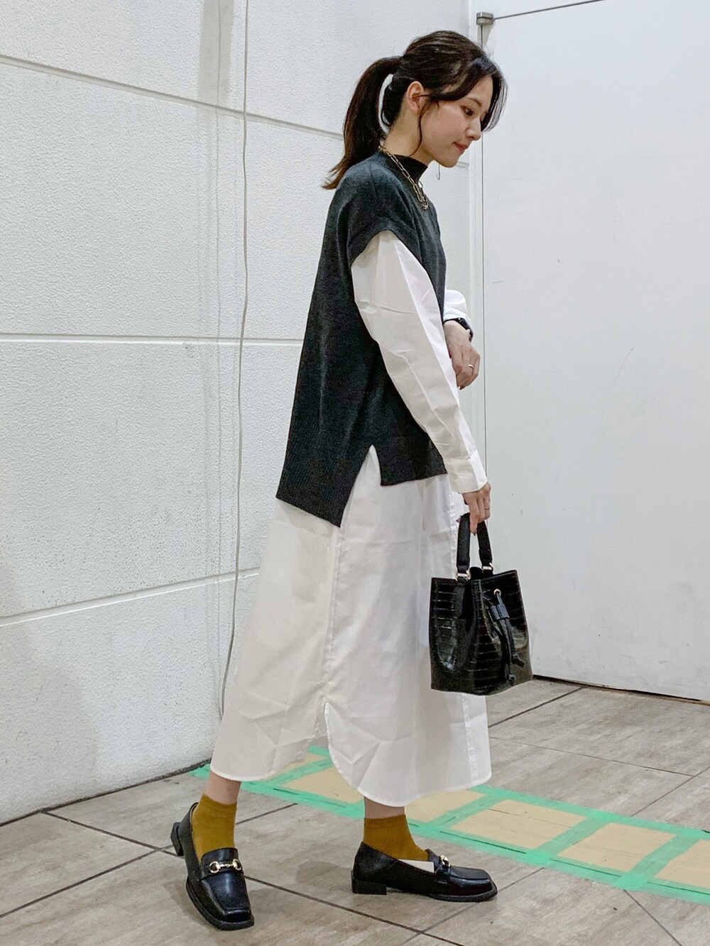 その他のショルダーバッグ、ブラック系のローファー、グレー系のワンピースを着用したレディースの秋コーディネートの4枚目の写真