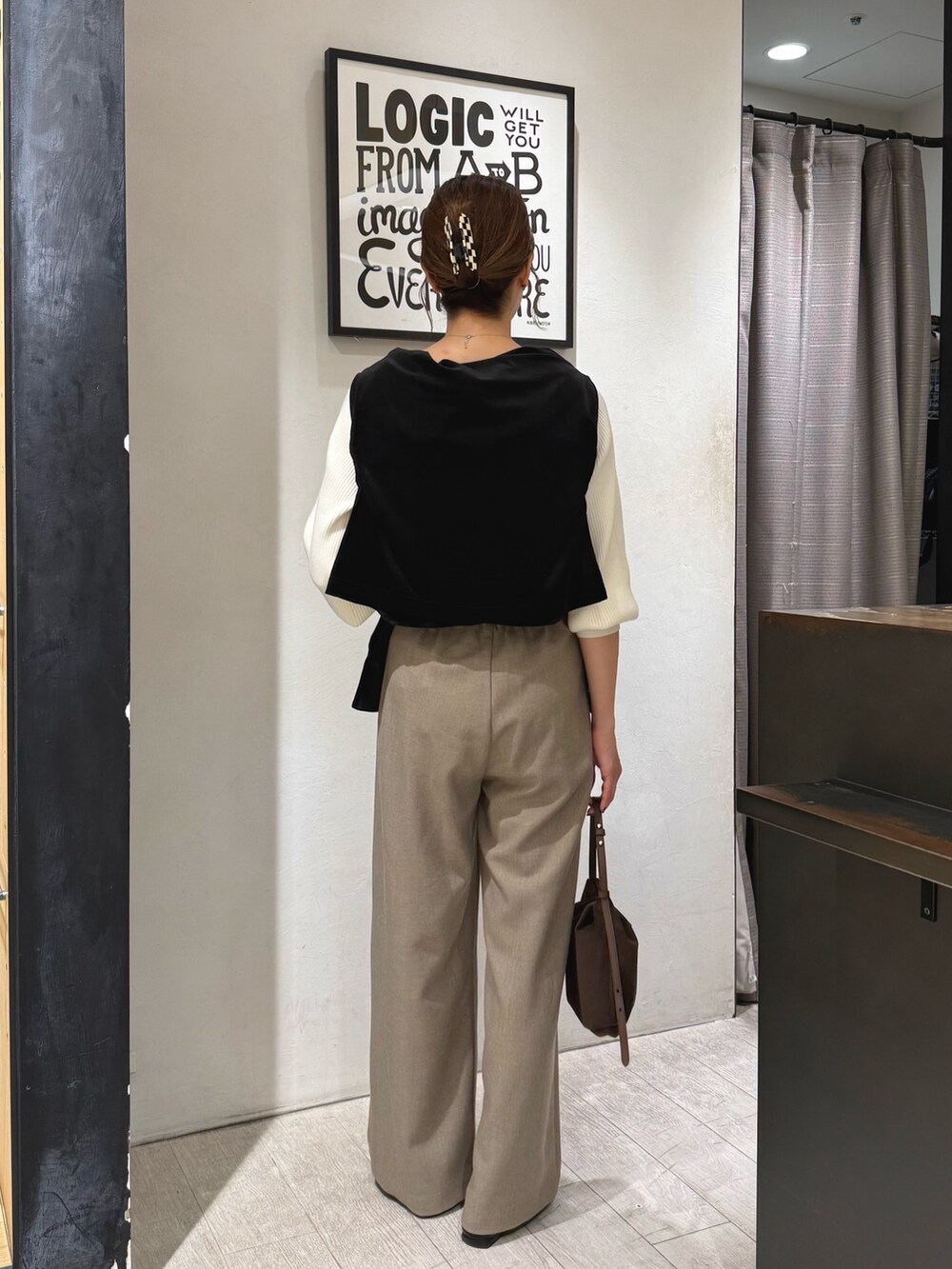 ホワイト系のニット/セーター、ベージュ系のその他パンツ、ブラウン系のショルダーバッグを着用したレディースの冬コーディネートの4枚目の写真
