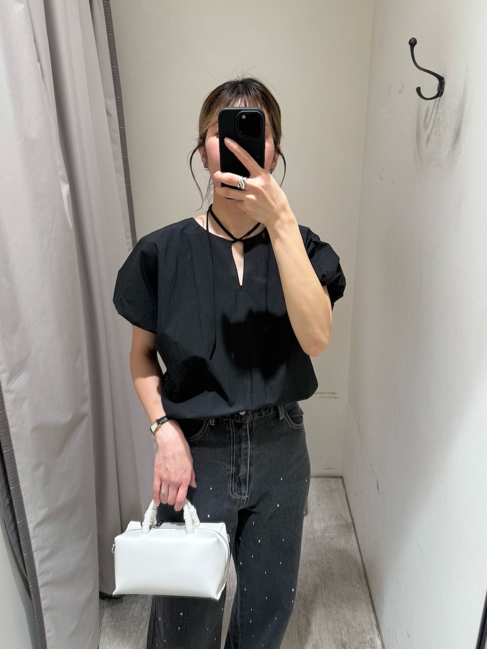 ブラック系のシャツ/ブラウス、ブラック系のデニムパンツ、ホワイト系のショルダーバッグを着用したレディースの春コーディネートの2枚目の写真