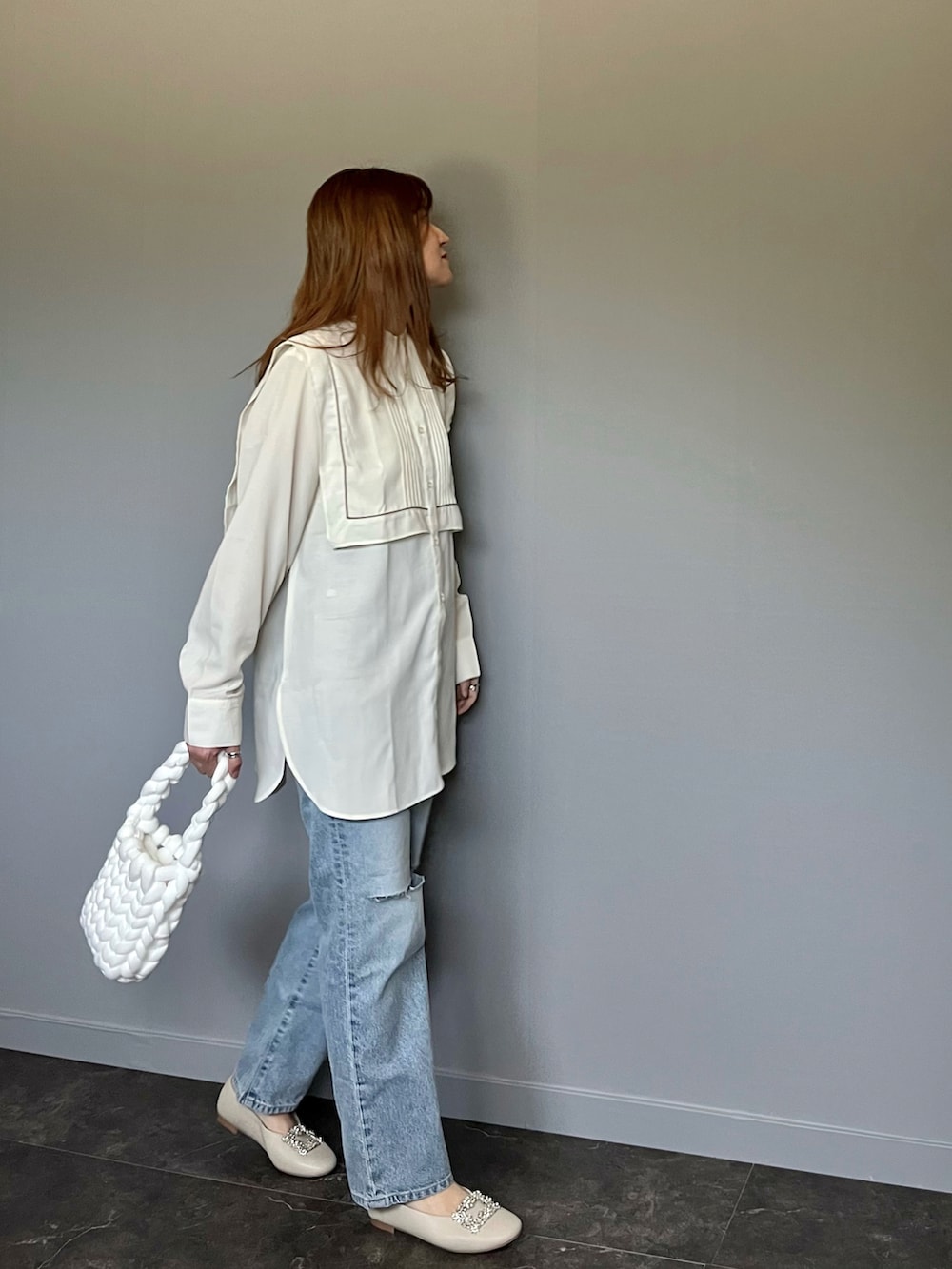 ブルー系のデニムパンツ、ホワイト系のシャツ/ブラウス、ホワイト系のハンドバッグを着用したレディースの春コーディネートの4枚目の写真