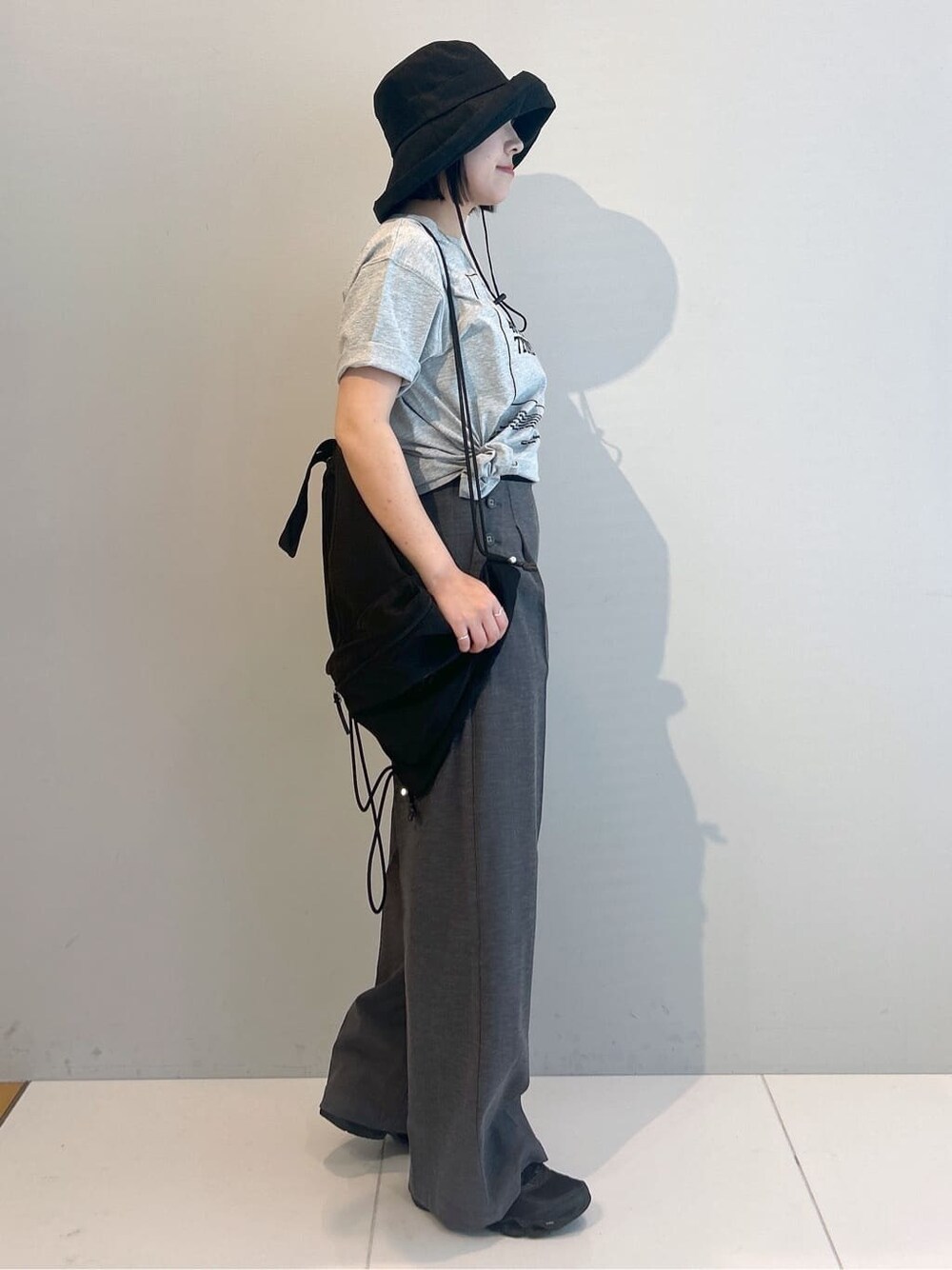 グレー系のTシャツ/カットソー、グレー系のその他パンツ、ブラック系のバックパック/リュックを着用したレディースの春コーディネートの4枚目の写真