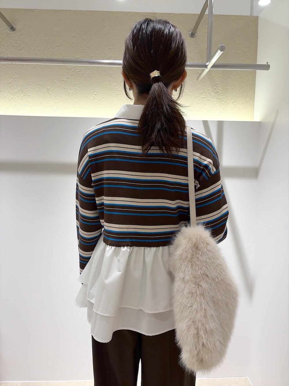 ブラウン系のニット/セーター、ブラウン系のその他パンツ、ホワイト系のショルダーバッグを着用したレディースの秋コーディネートの9枚目の写真