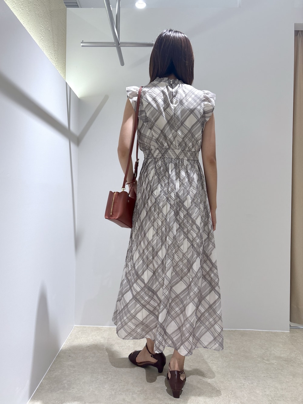 ベージュ系のワンピース、レッド系のショルダーバッグ、ブラウン系のサンダルを着用したレディースの夏コーディネートの4枚目の写真
