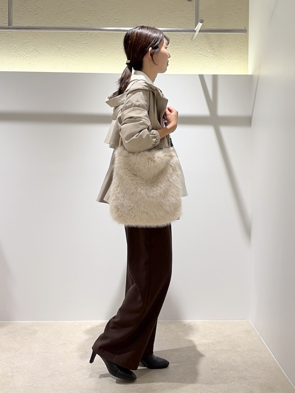 ベージュ系のマウンテンパーカー、ブラウン系のニット/セーター、ブラウン系のブーツを着用したレディースの秋コーディネートの4枚目の写真