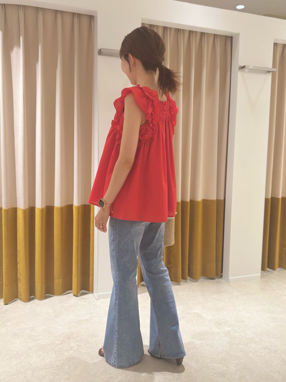 レッド系のシャツ/ブラウス、ベージュ系のバッグ、ブラウン系のサンダルを着用したレディースの夏コーディネートの3枚目の写真