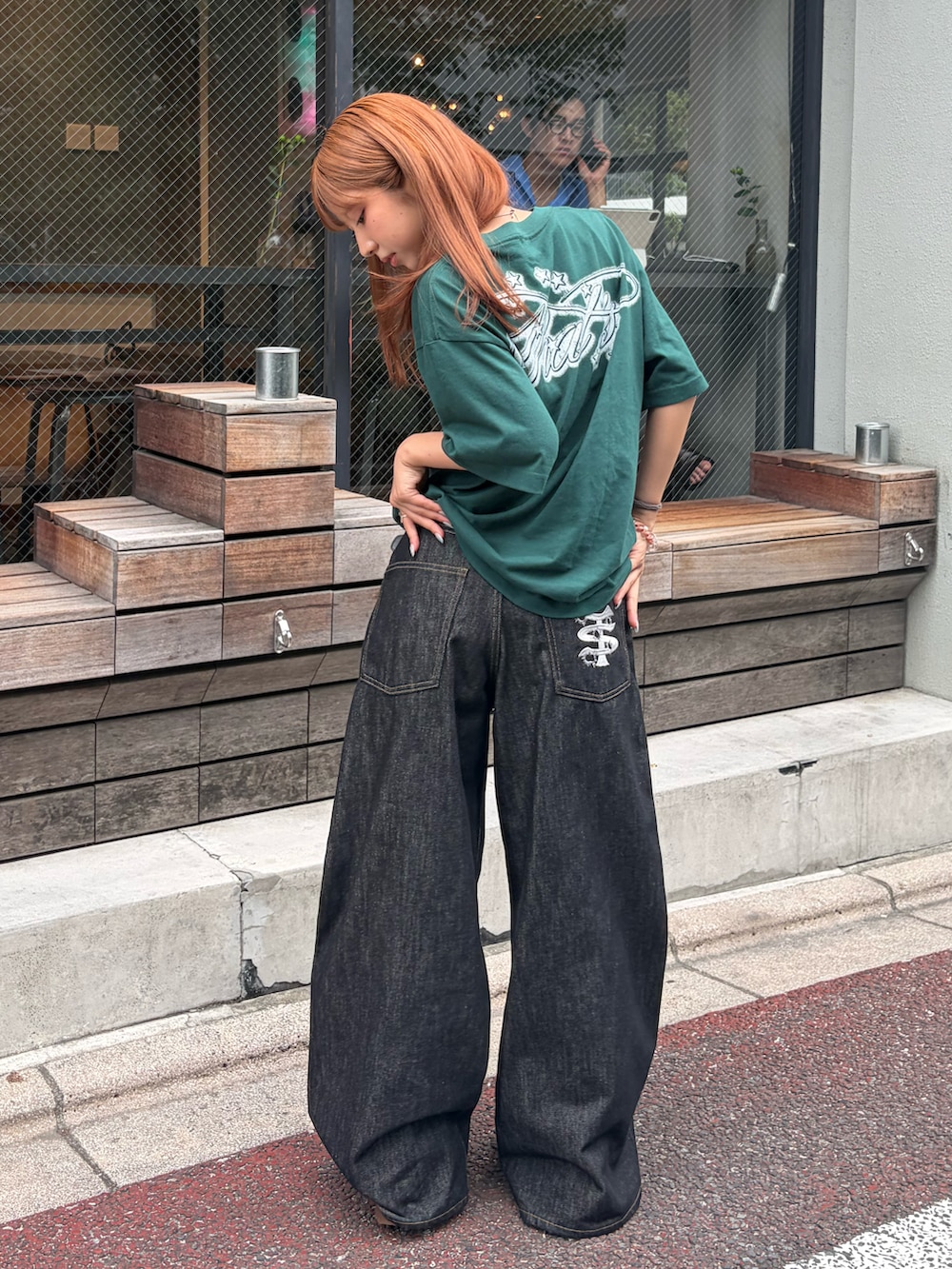 グリーン系のTシャツ/カットソー、ブラック系のデニムパンツ、イエロー系のブーツを着用したレディースの夏コーディネートの2枚目の写真
