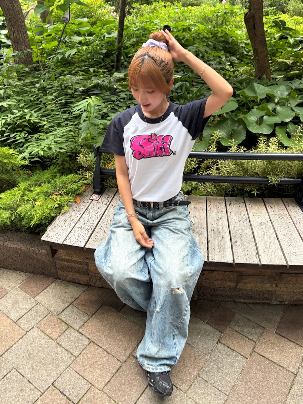 ブルー系のデニムパンツ、ブラック系のスニーカーを着用したレディースの夏コーディネートの2枚目の写真