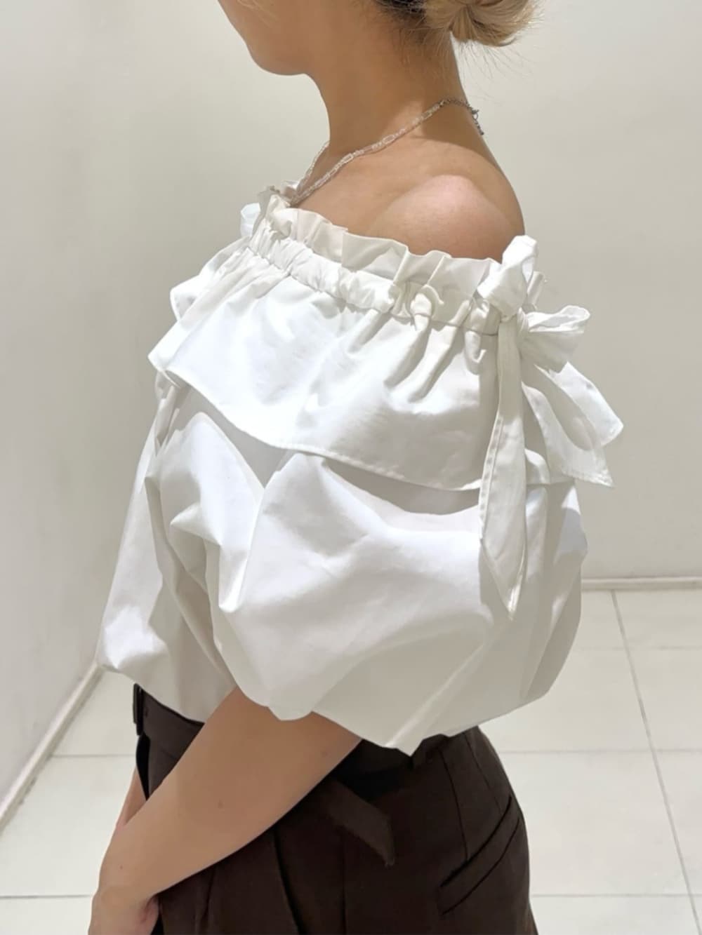 ホワイト系のシャツ/ブラウス、ブラウン系のその他パンツ、ホワイト系のボストンバッグを着用したレディースの夏コーディネートの6枚目の写真