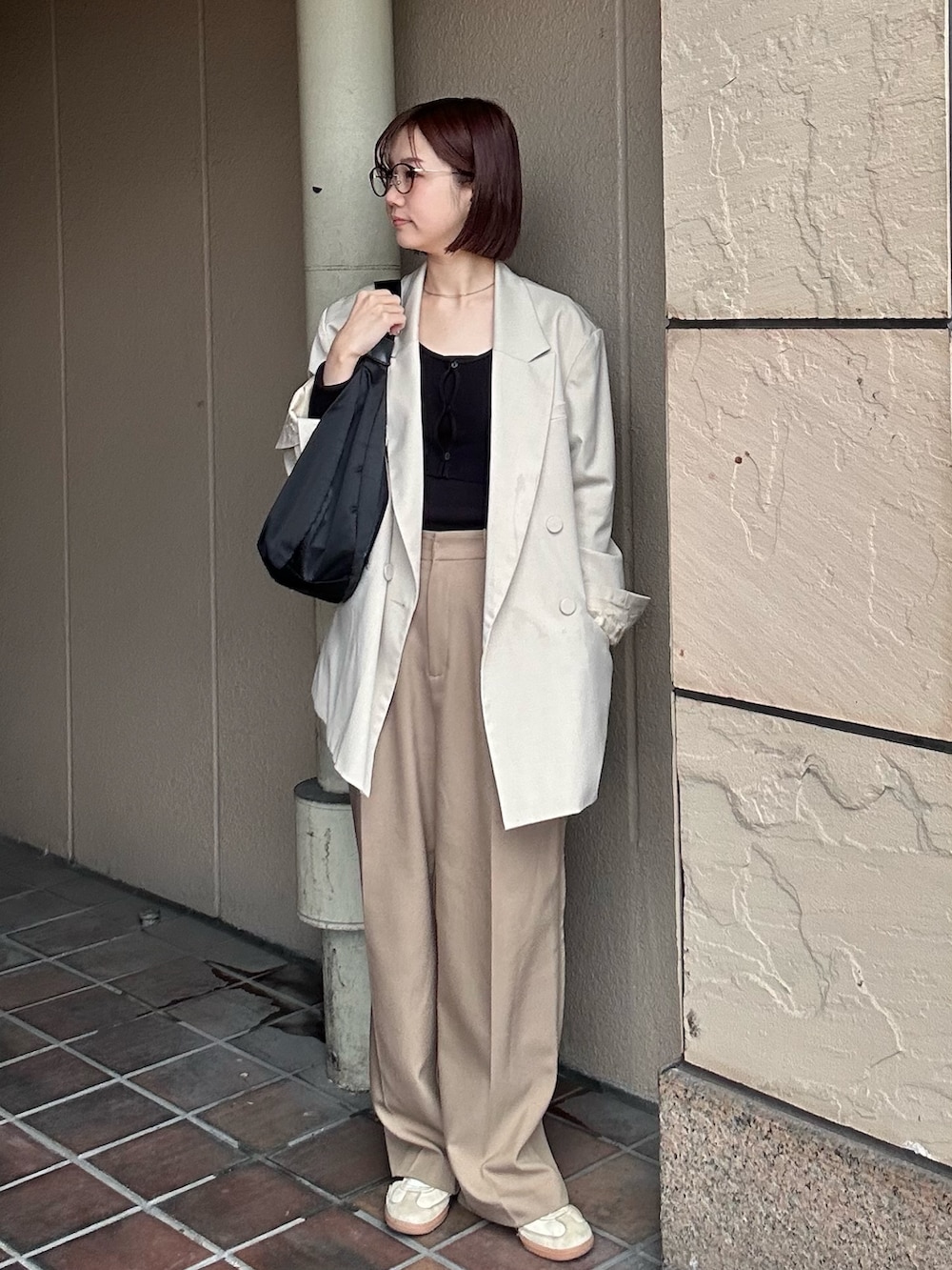 ブラック系のショルダーバッグを着用したレディースの春コーディネートの2枚目の写真