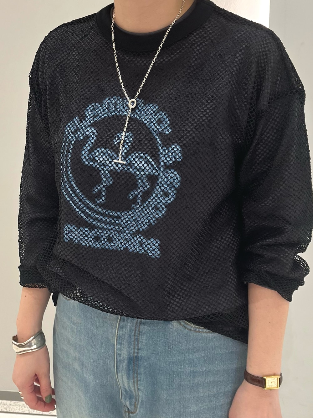 グレー系のTシャツ/カットソー、ブラック系のTシャツ/カットソー、ブルー系のデニムパンツを着用したレディースの秋コーディネートの2枚目の写真