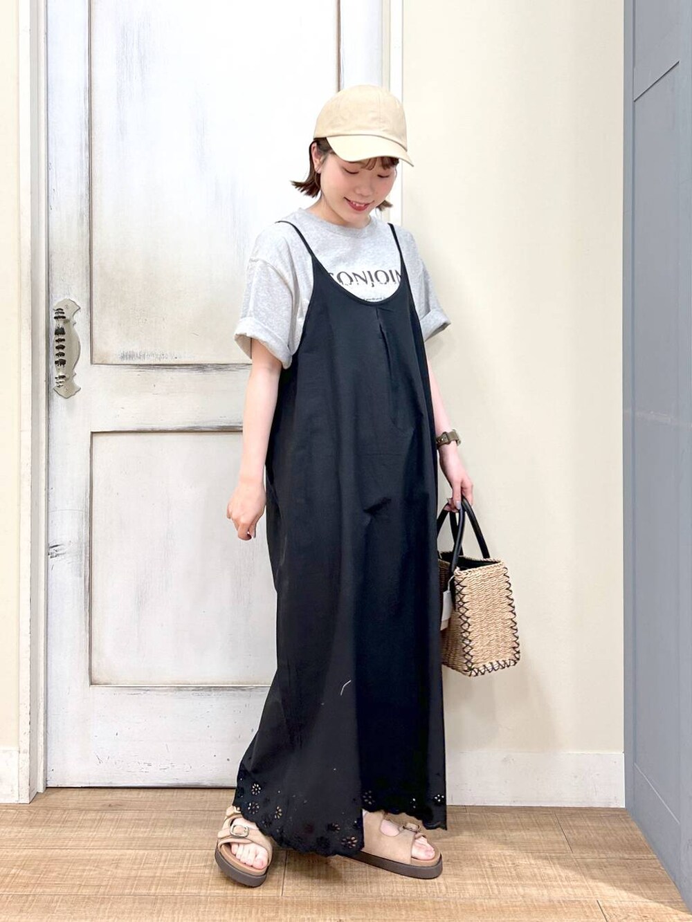 ブラック系のショルダーバッグ、ベージュ系のサンダル、グレー系のTシャツ/カットソーを着用したレディースの春コーディネートの2枚目の写真