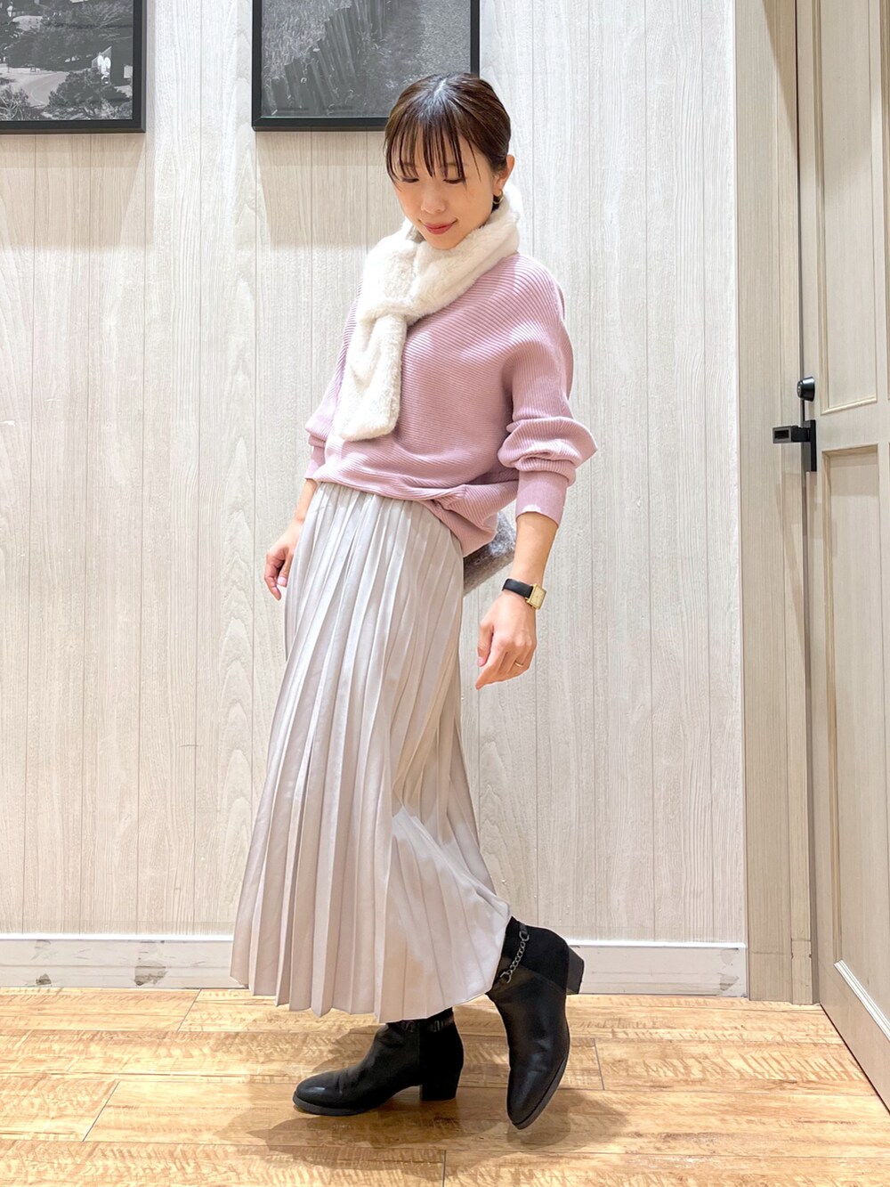 ベージュ系のスカート、ピンク系のニット/セーター、ベージュ系のショルダーバッグを着用したレディースの冬コーディネートの2枚目の写真