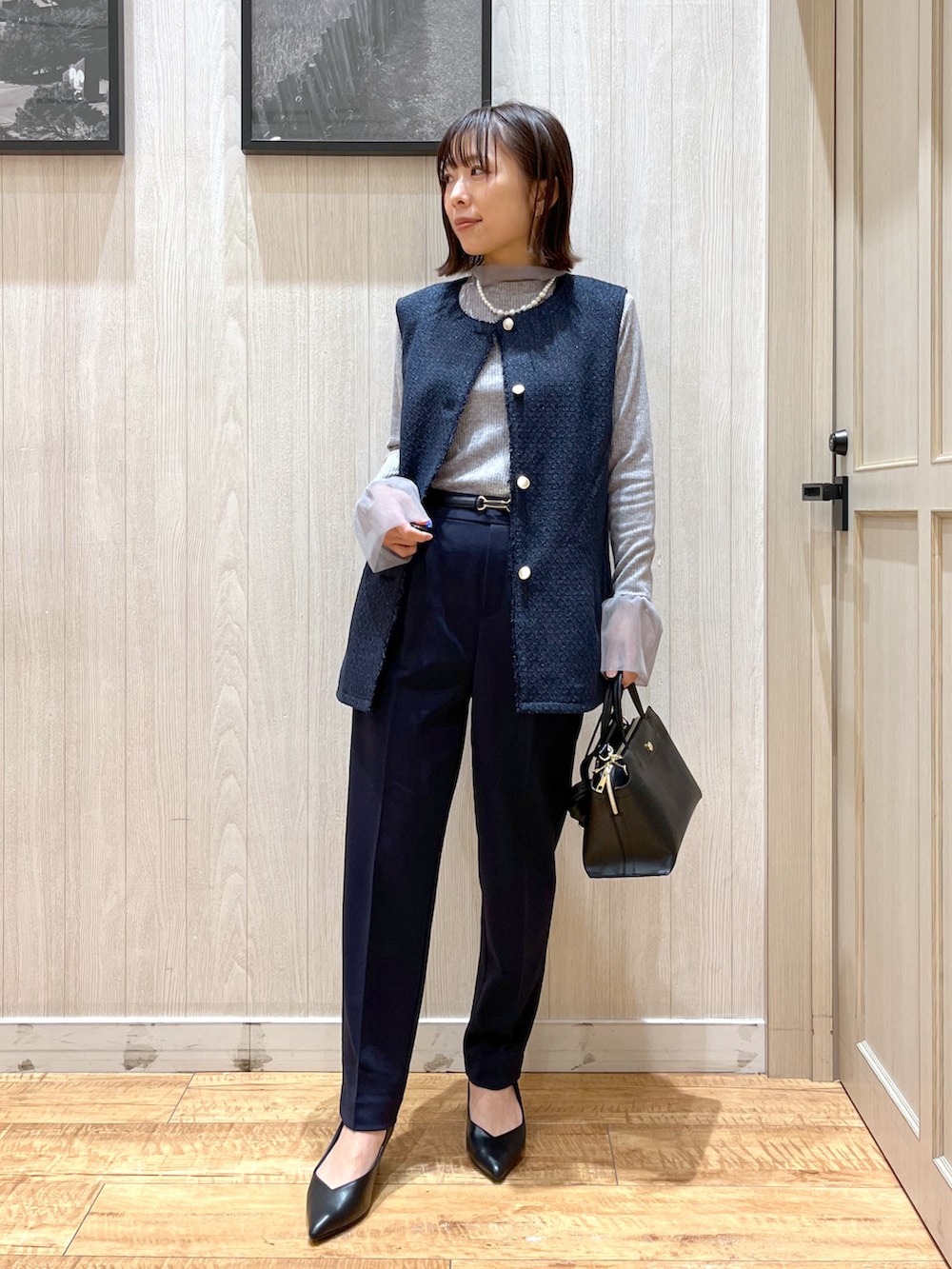 ブルー系のベスト、ブルー系のその他パンツ、ブラック系のトートバッグを着用したレディースの冬コーディネートの3枚目の写真