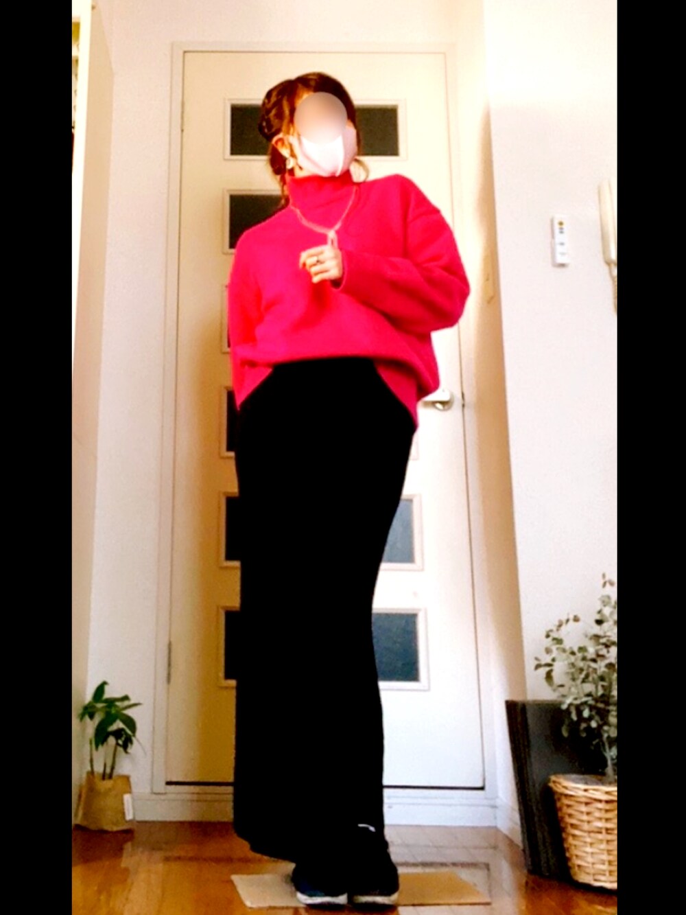 ピンク系のニット/セーター、ブラック系のスカート、ブラック系のスニーカーを着用したレディースの春コーディネートの2枚目の写真