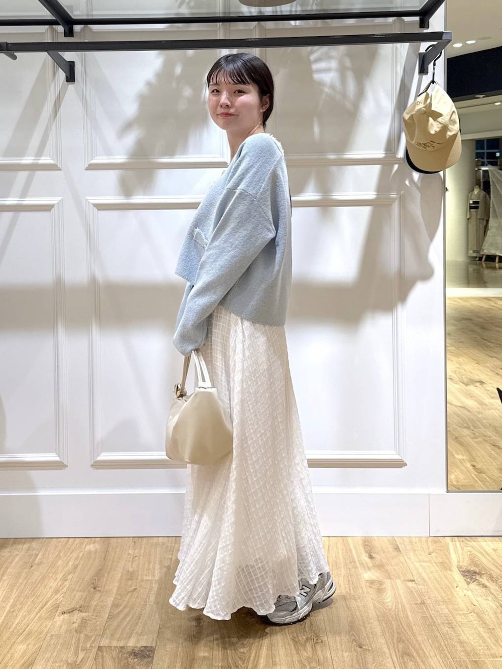 ブルー系のカーディガン/ボレロ、ホワイト系のスカートを着用したレディースの春コーディネートの4枚目の写真