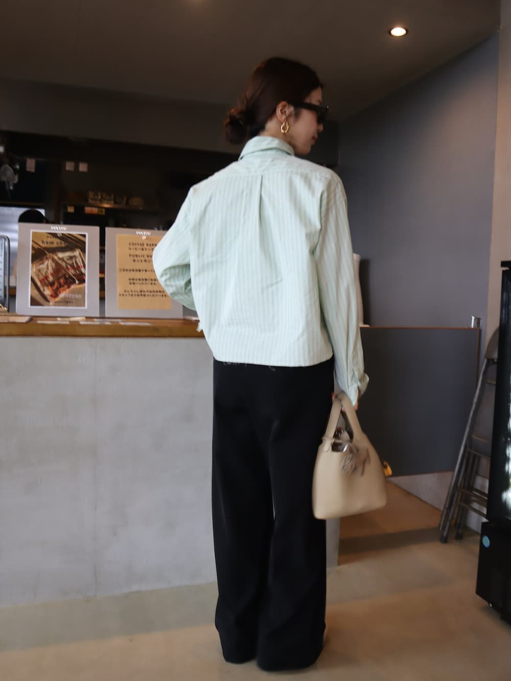 ブラック系のスニーカー、グリーン系のシャツ/ブラウス、ブラック系のその他パンツを着用したレディースの秋コーディネートの4枚目の写真