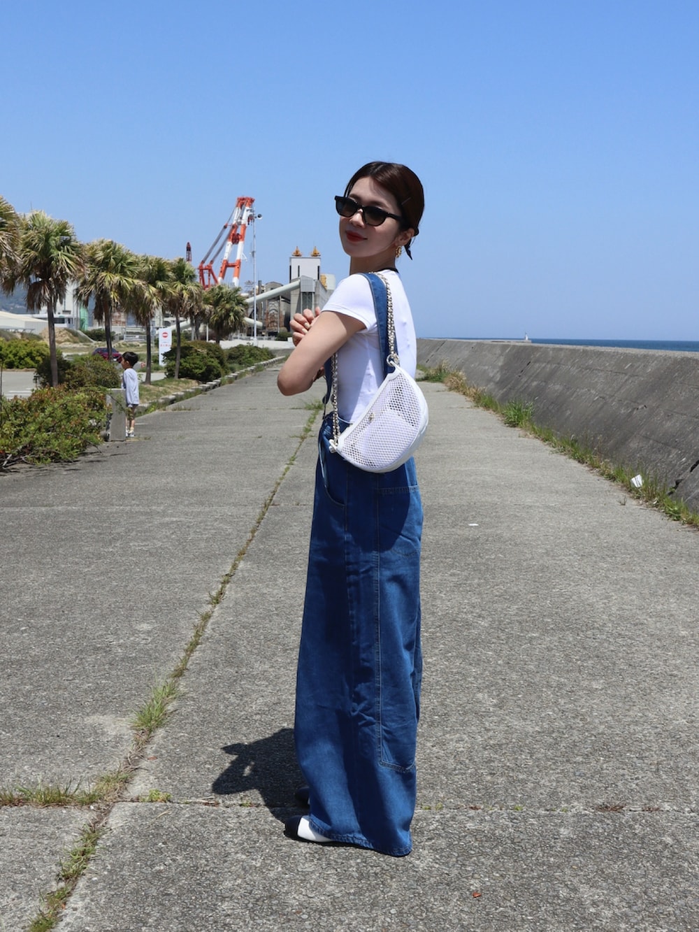 ホワイト系のTシャツ/カットソー、ブルー系のつなぎ/オールインワン、ホワイト系のバレエシューズを着用したレディースの春コーディネートの2枚目の写真