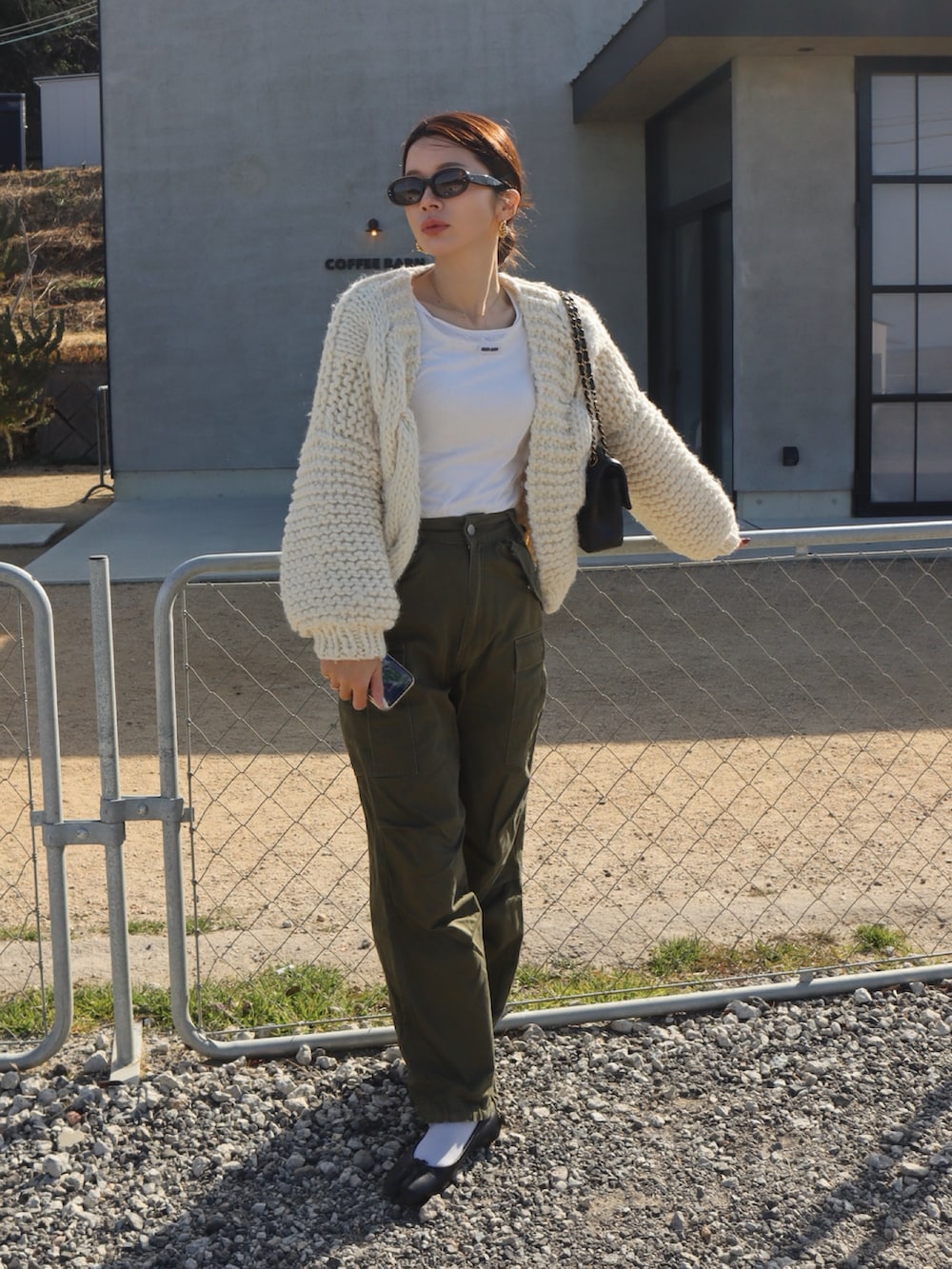 グレー系のその他トップス、グリーン系のカーゴパンツ、ブラック系のバレエシューズを着用したレディースの冬コーディネートの2枚目の写真