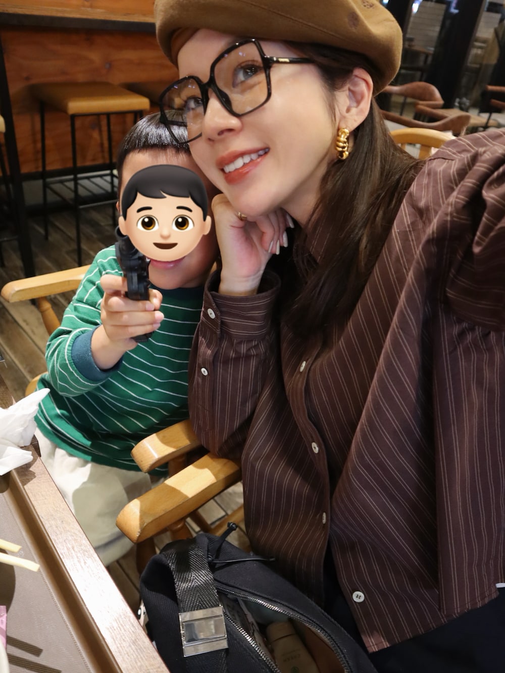 ブラック系のステンカラーコート、ブラック系のローファー、ブラウン系のハンチング/ベレー帽を着用したレディースの冬コーディネートの3枚目の写真