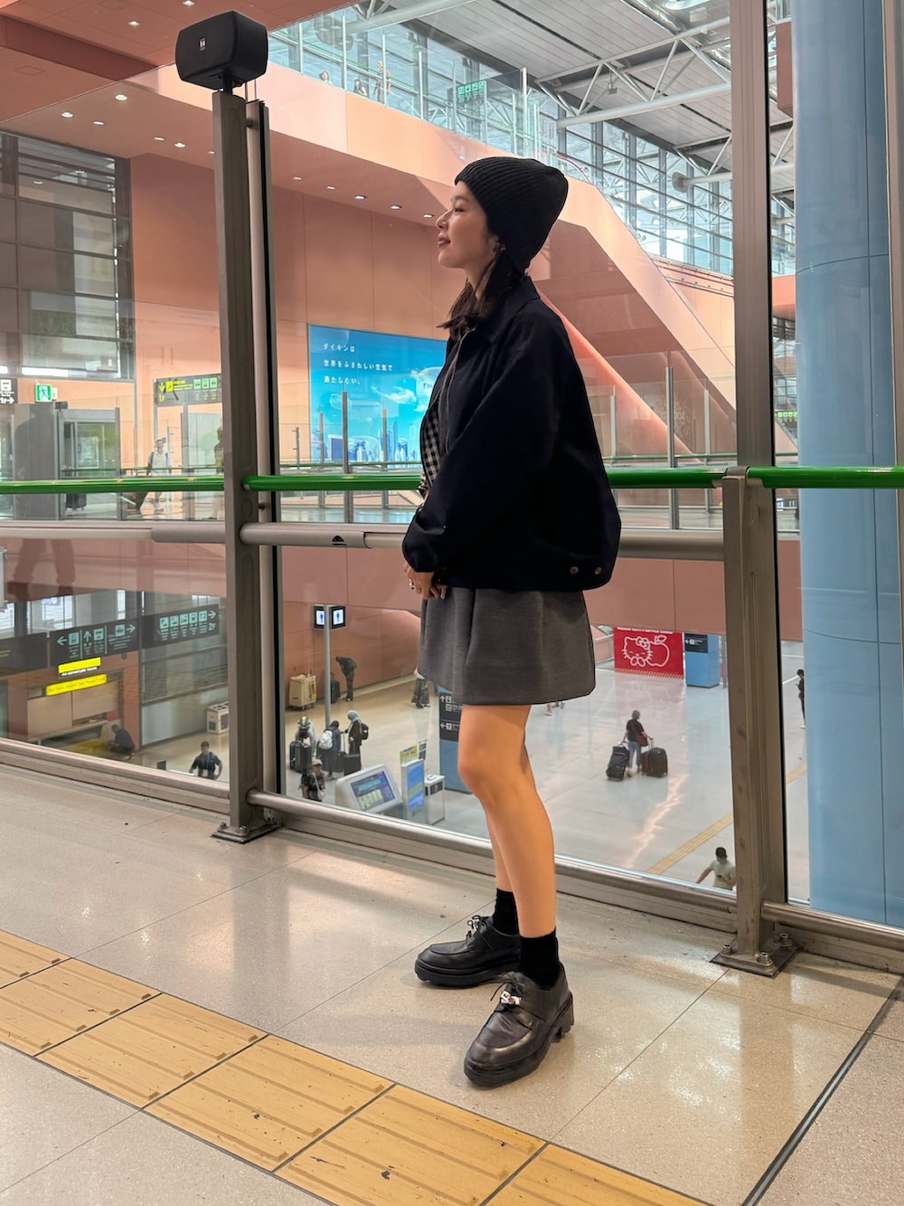 ブルー系のジャケット/アウター、グレー系のスカート、ブラック系のローファーを着用したレディースの秋コーディネートの2枚目の写真