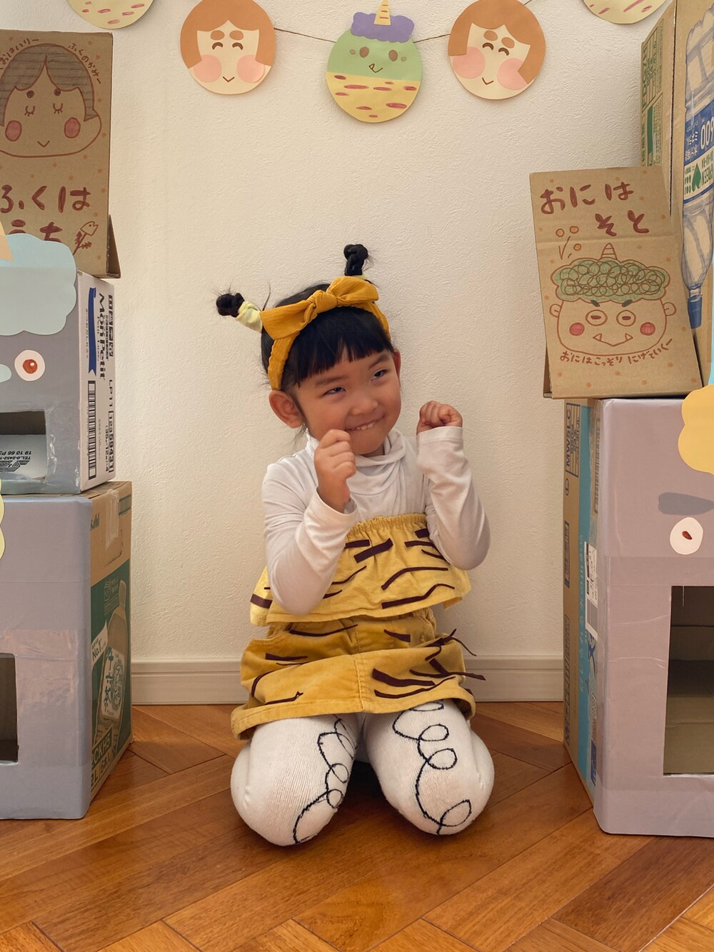 イエロー系のスカート、ホワイト系のタイツ/ストッキング、イエロー系のスタイ/よだれかけを着用したキッズの冬コーディネートの3枚目の写真