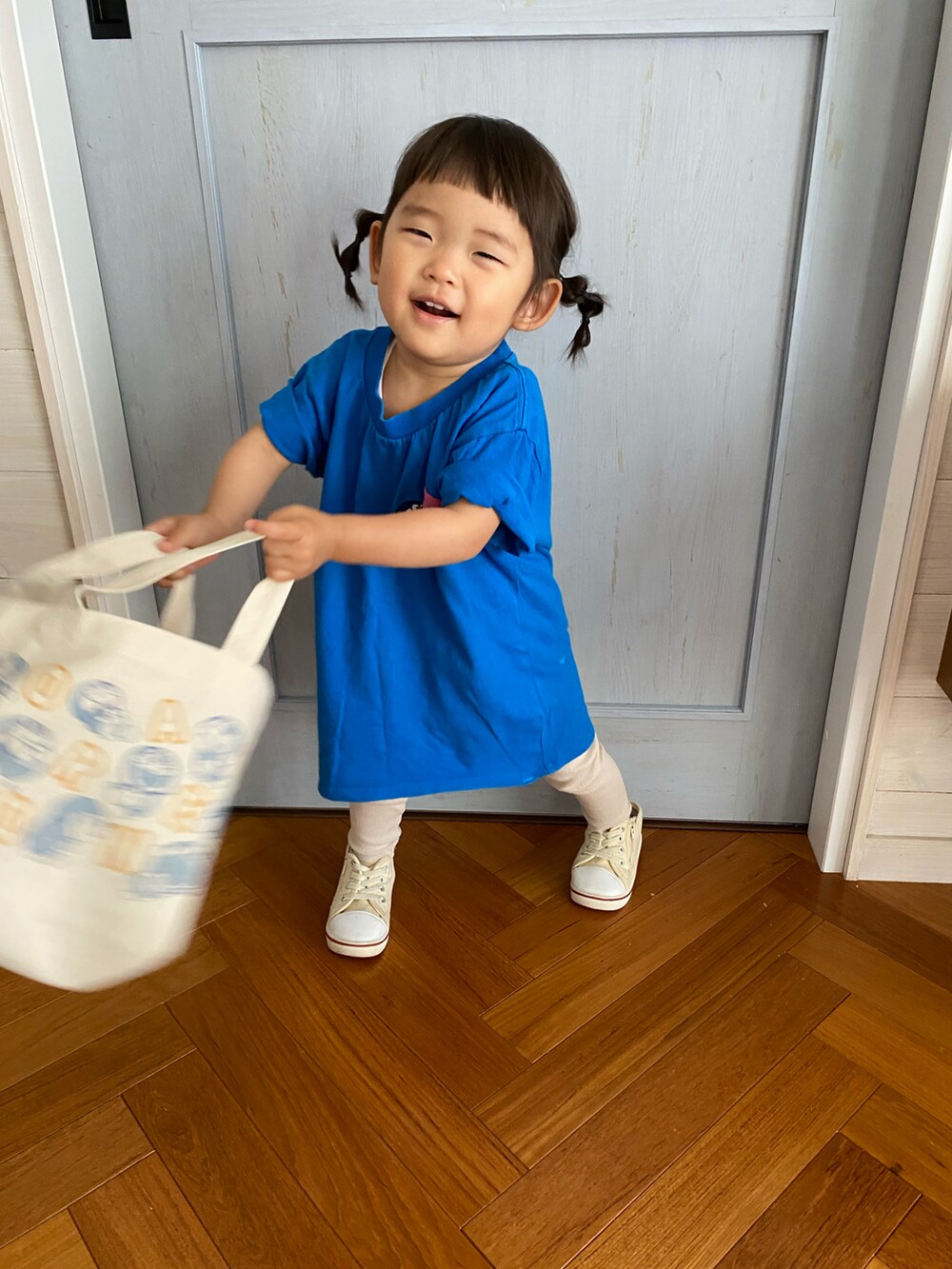 ブルー系のTシャツ/カットソー、ベージュ系のトートバッグを着用したキッズの夏コーディネートの3枚目の写真