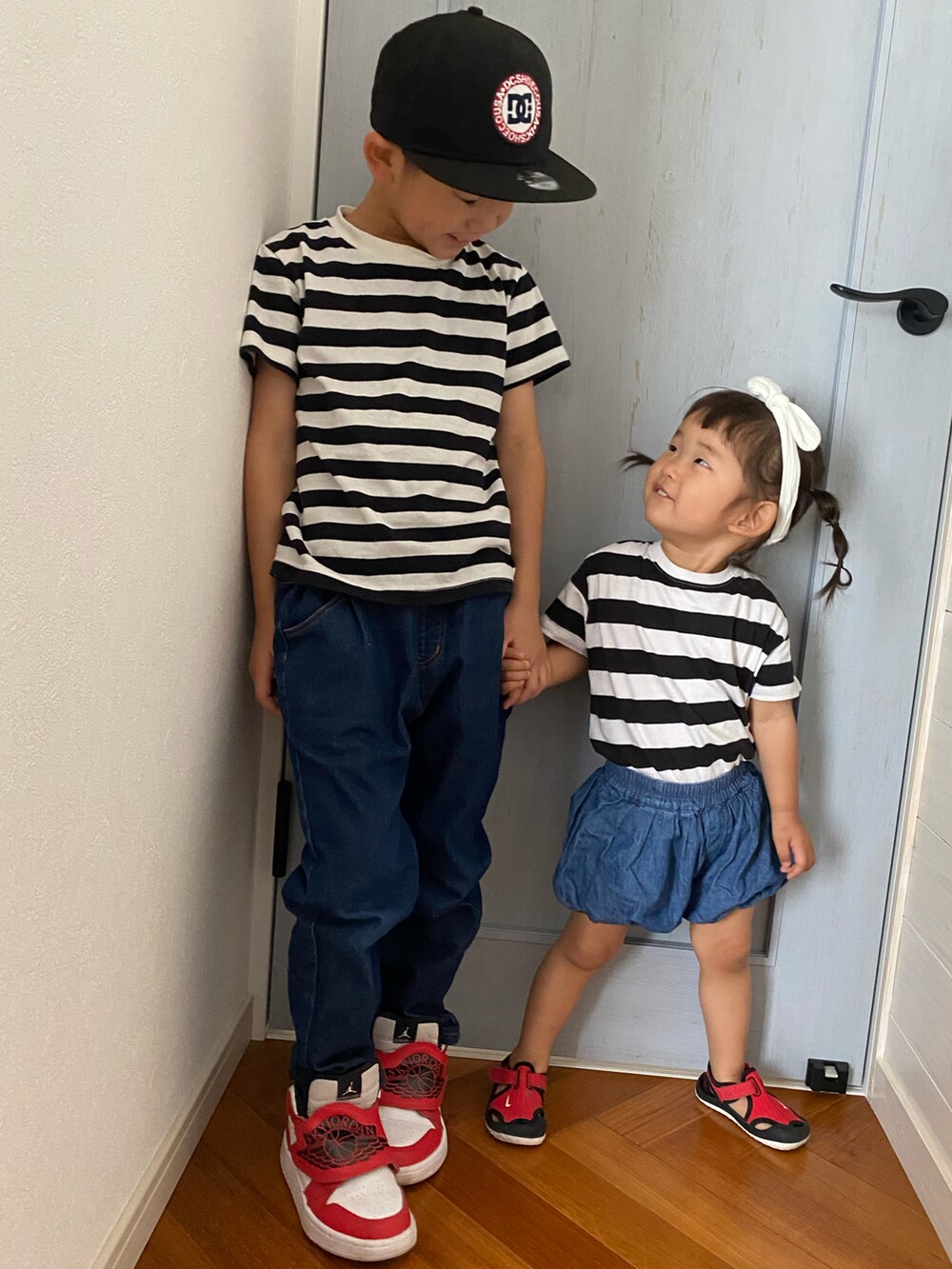 ホワイト系のTシャツ/カットソー、ブラック系のTシャツ/カットソー、レッド系のサンダルを着用したキッズの夏コーディネートの2枚目の写真