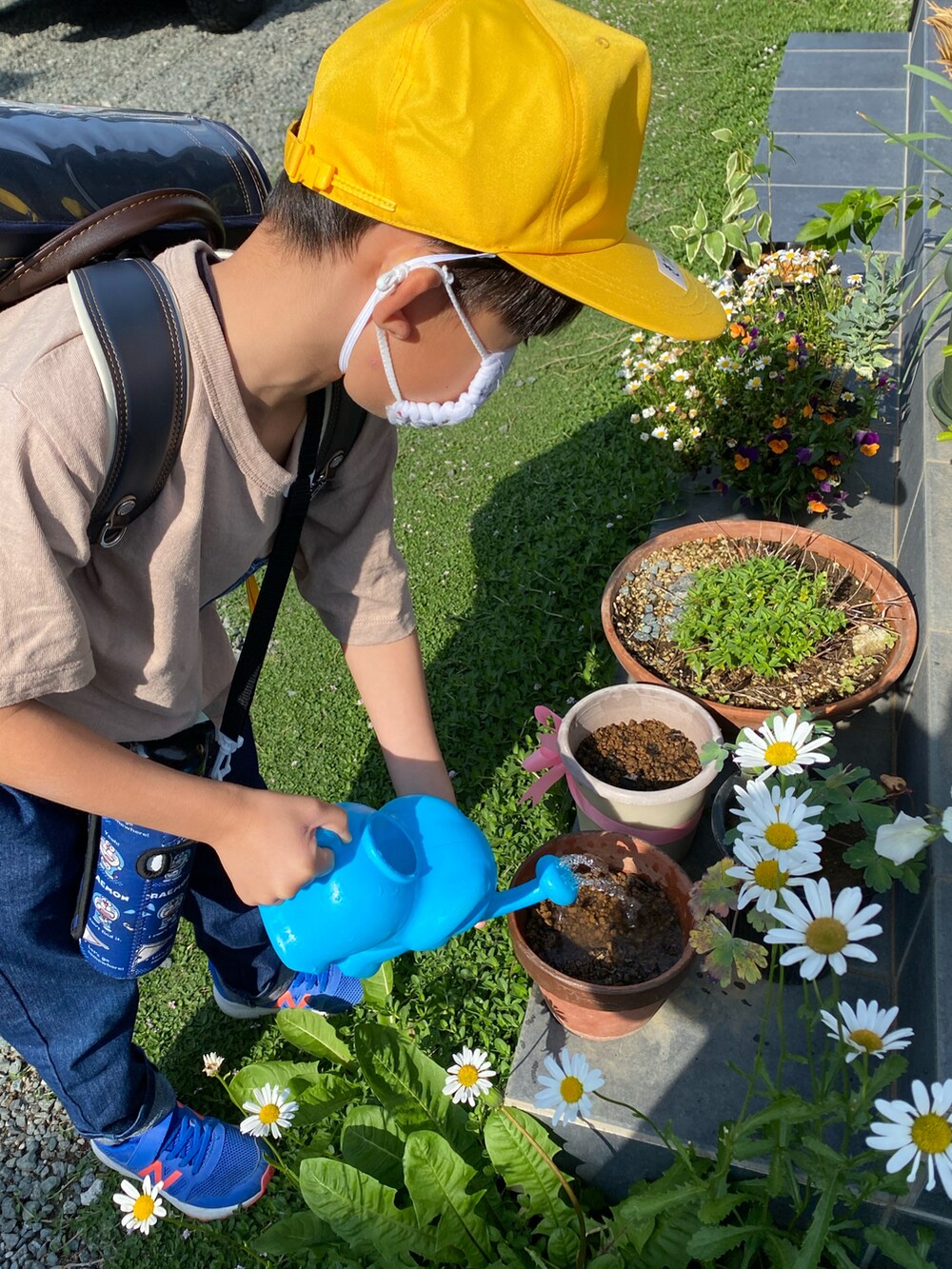 ベージュ系のTシャツ/カットソー、ブルー系のデニムパンツを着用したキッズの春コーディネートの2枚目の写真