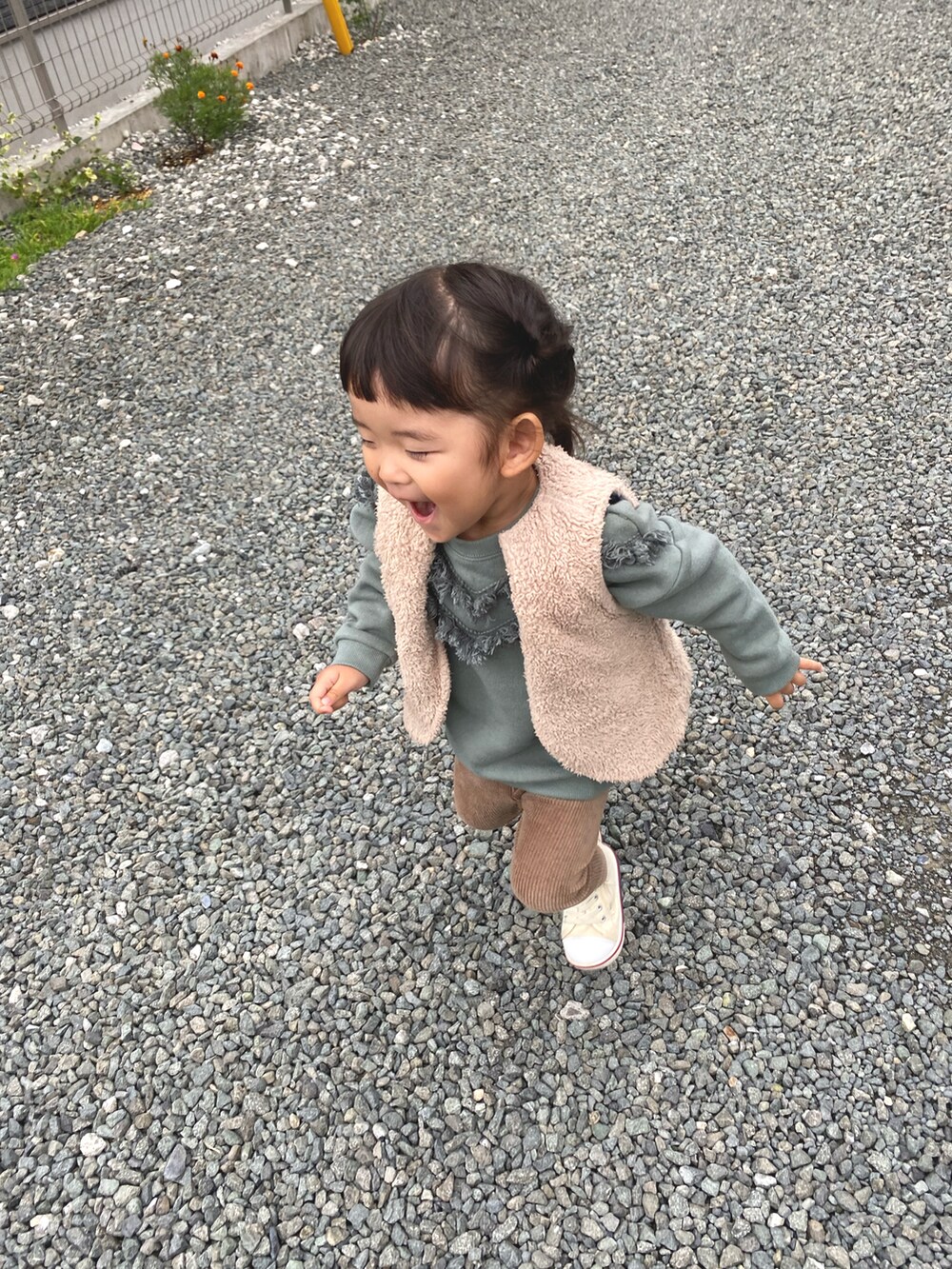 グリーン系のスウェット、ホワイト系のスニーカー、ブラウン系のレギンス/スパッツを着用したキッズの秋コーディネートの2枚目の写真